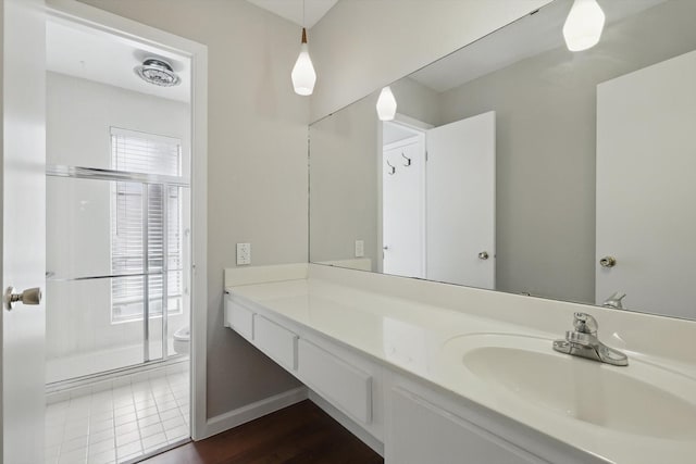 bathroom featuring vanity, toilet, and baseboards