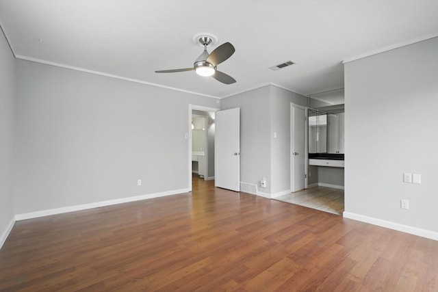 interior space with ornamental molding, visible vents, baseboards, and wood finished floors