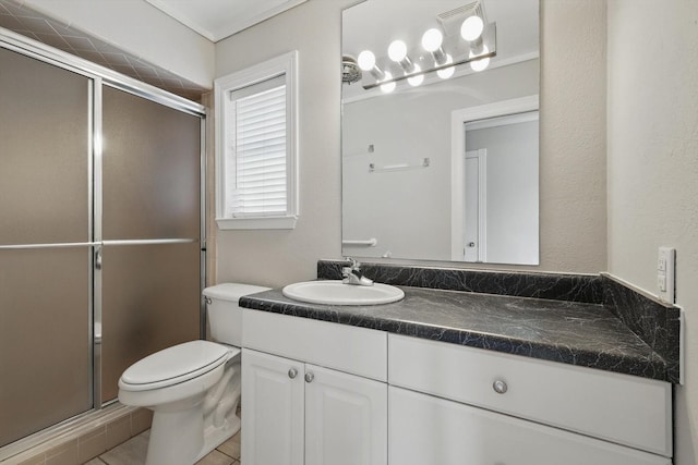 full bath featuring a stall shower, vanity, and toilet