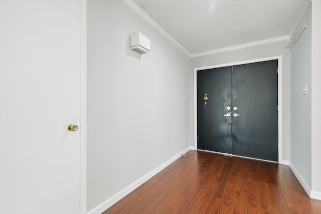 entryway with baseboards, ornamental molding, and wood finished floors