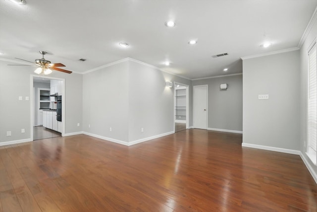 unfurnished living room with ceiling fan, wood finished floors, visible vents, and baseboards