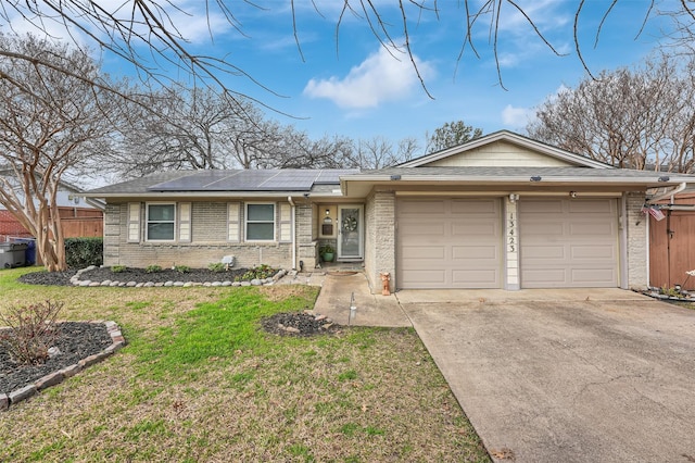 single story home featuring a garage, a front yard, and solar panels