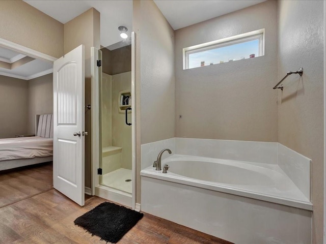 bathroom featuring hardwood / wood-style flooring and shower with separate bathtub