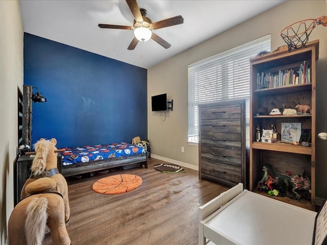 bedroom with hardwood / wood-style flooring and ceiling fan