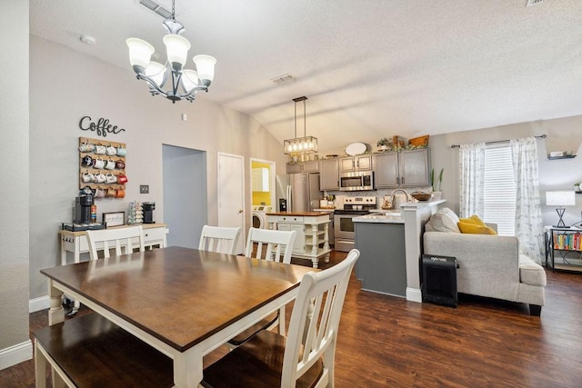 dining area with lofted ceiling, a notable chandelier, and dark hardwood / wood-style flooring