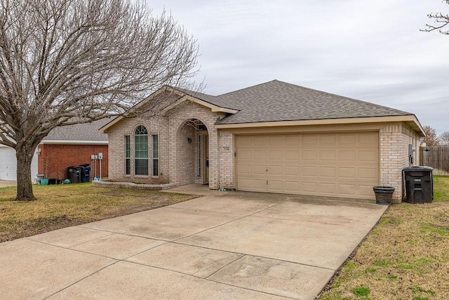 ranch-style home with a garage and a front lawn