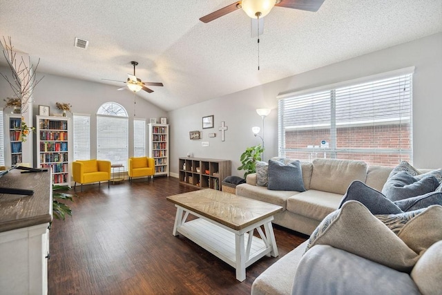 living room featuring vaulted ceiling, dark wood-type flooring, ceiling fan, and a textured ceiling