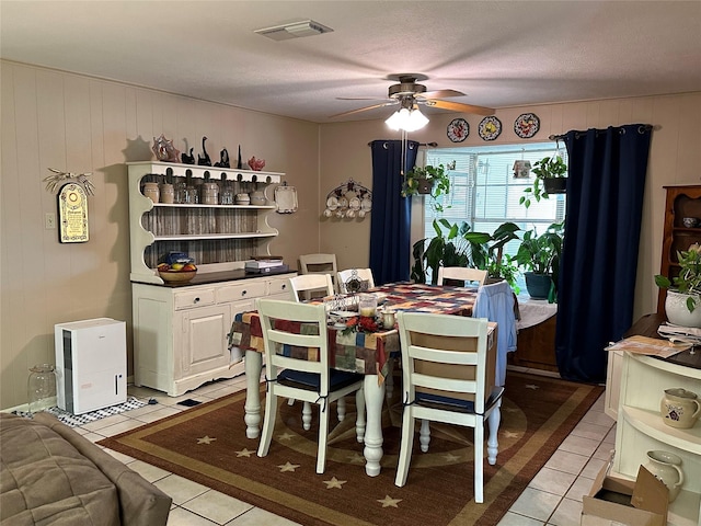 dining area with ceiling fan and light tile patterned floors