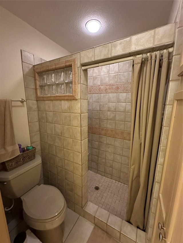 bathroom featuring walk in shower, tile patterned floors, toilet, and a textured ceiling