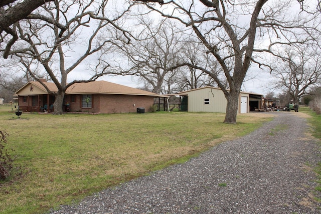 view of home's exterior with a garage, a lawn, and central air condition unit