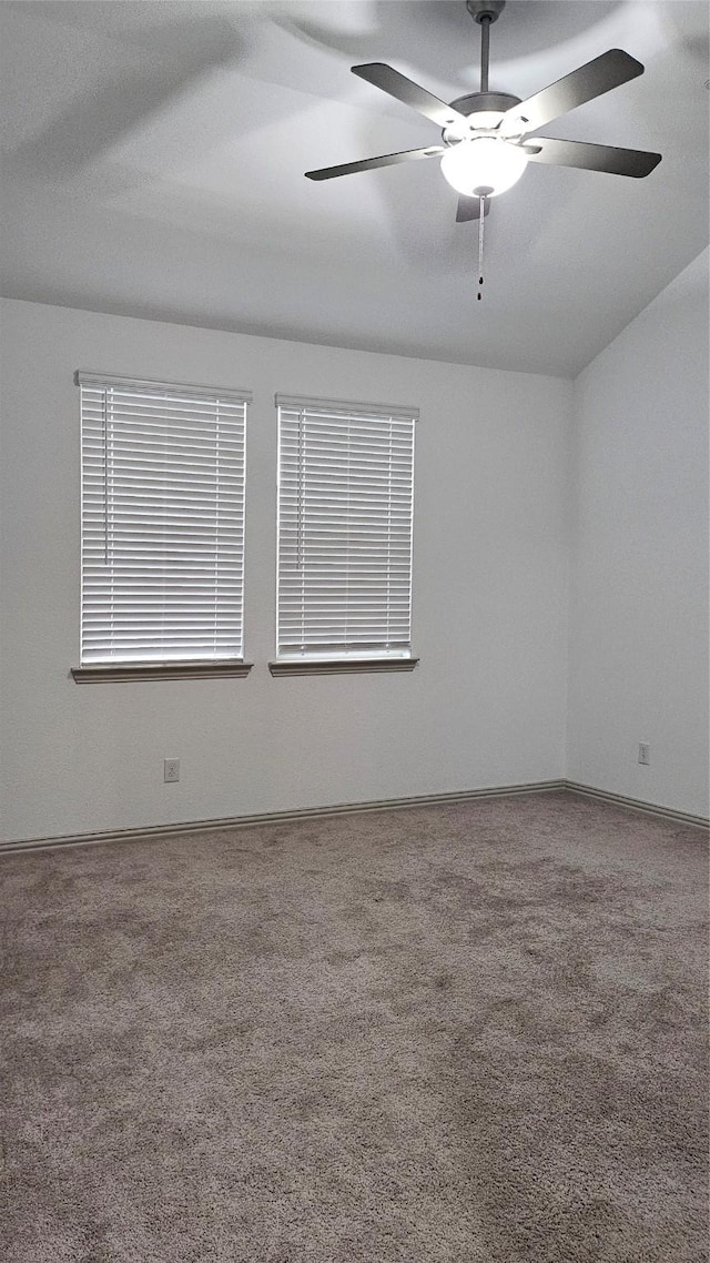 empty room featuring ceiling fan and carpet floors