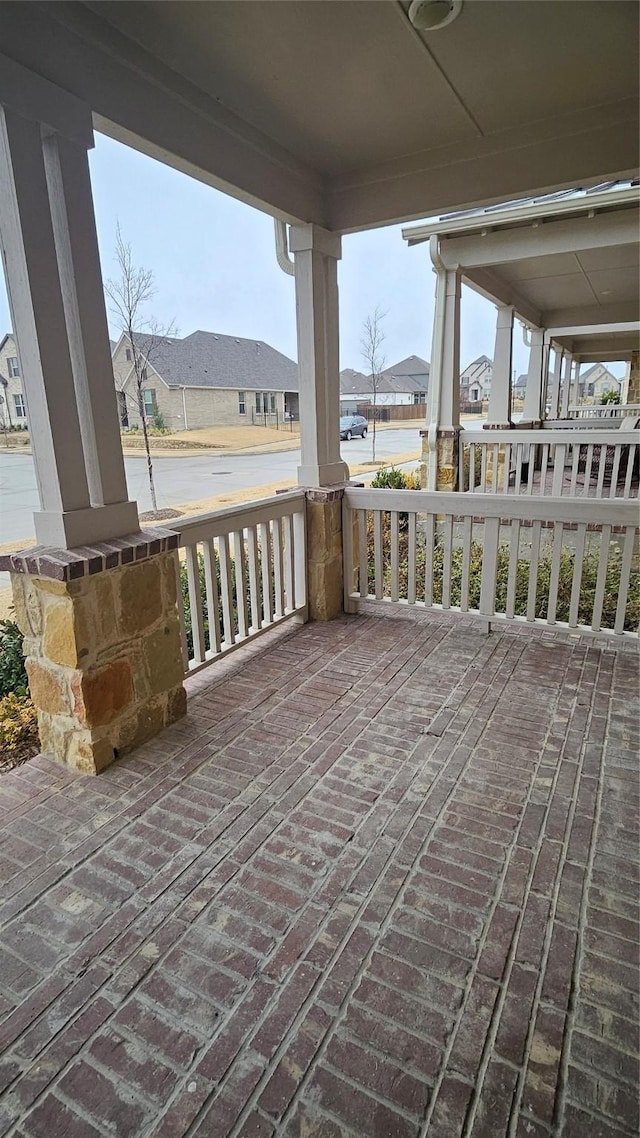 view of patio featuring covered porch and a residential view