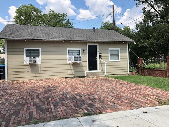 view of front of house featuring cooling unit and a patio