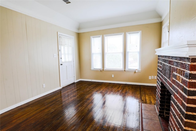 unfurnished living room featuring lofted ceiling and dark hardwood / wood-style floors