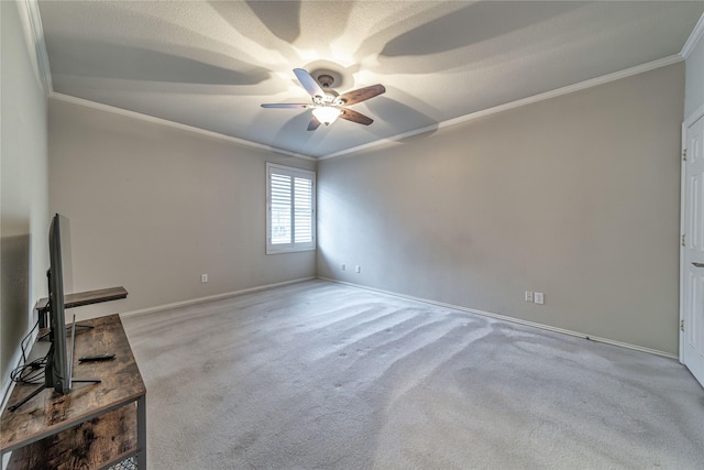 carpeted empty room with ornamental molding and ceiling fan