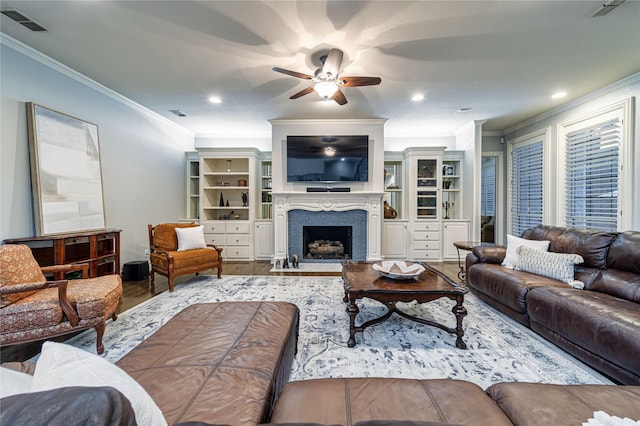 living room with crown molding, ceiling fan, and wood-type flooring