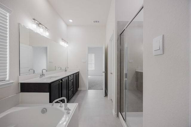 bathroom featuring plus walk in shower, tile patterned flooring, and vanity