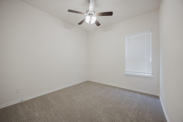 spare room featuring carpet and ceiling fan