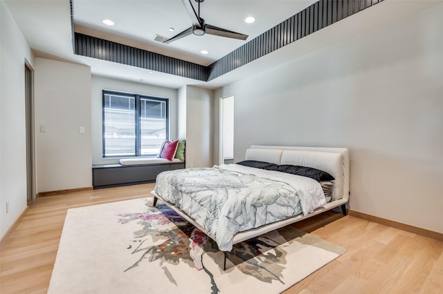 bedroom with ceiling fan and light hardwood / wood-style flooring