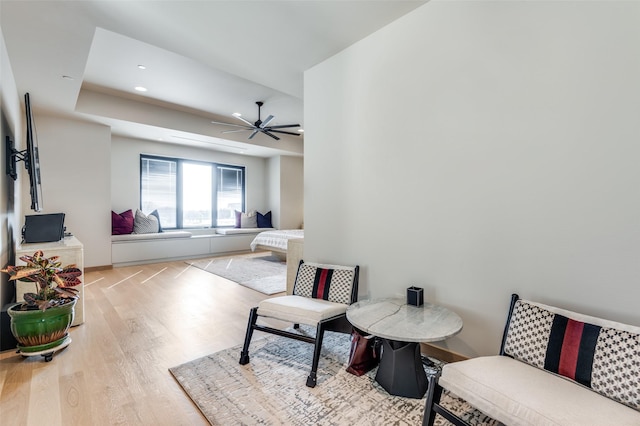 living room featuring ceiling fan and light hardwood / wood-style flooring