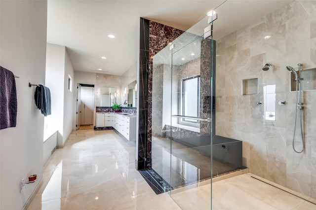 bathroom with vanity and a shower with door