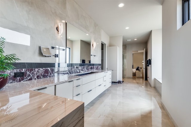 bathroom featuring tasteful backsplash and vanity