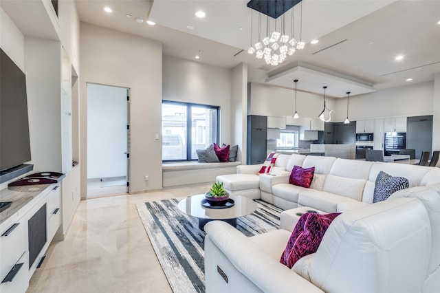 living room featuring a high ceiling and an inviting chandelier