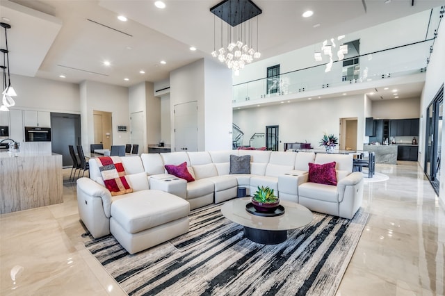 living room featuring an inviting chandelier and a high ceiling