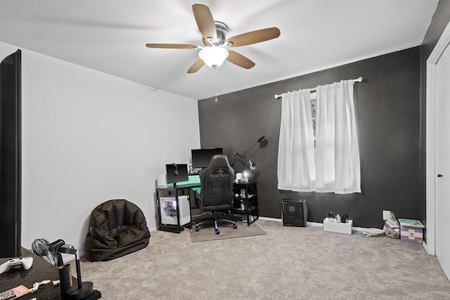 carpeted office space with ceiling fan