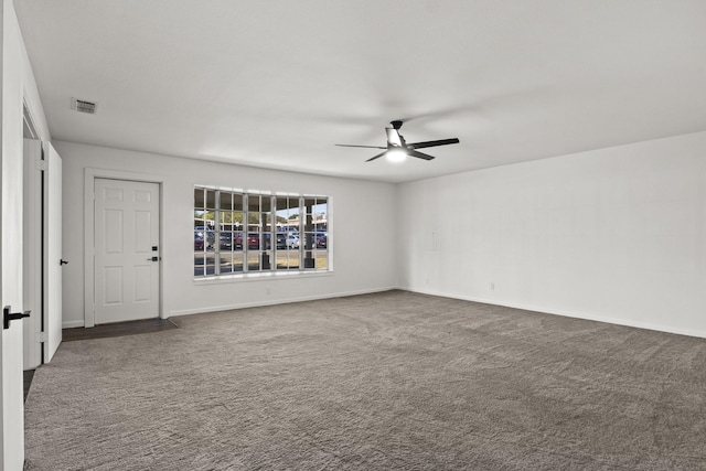 carpeted spare room with ceiling fan