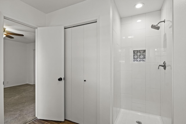 bathroom with ceiling fan and a tile shower