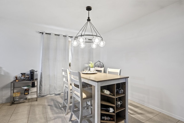 tiled dining area featuring a notable chandelier