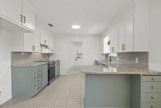 kitchen with kitchen peninsula, stainless steel electric stove, light stone countertops, and white cabinets