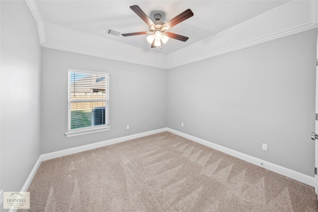 spare room featuring ceiling fan, ornamental molding, and carpet