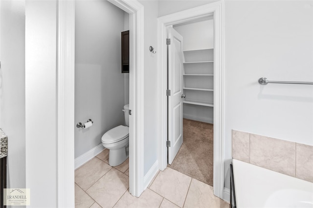 bathroom with tile patterned flooring and toilet