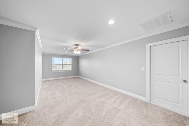 carpeted spare room featuring ceiling fan and ornamental molding