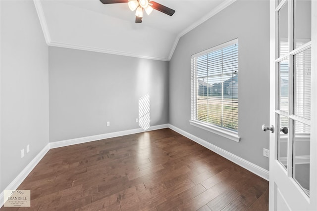 empty room featuring dark wood-type flooring, ceiling fan, crown molding, and vaulted ceiling