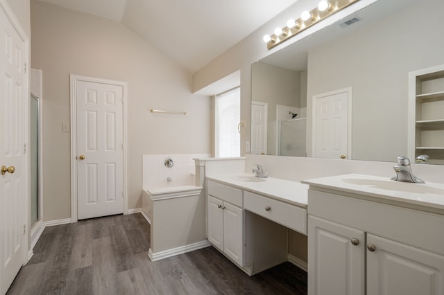 bathroom with vanity, plus walk in shower, vaulted ceiling, and hardwood / wood-style floors