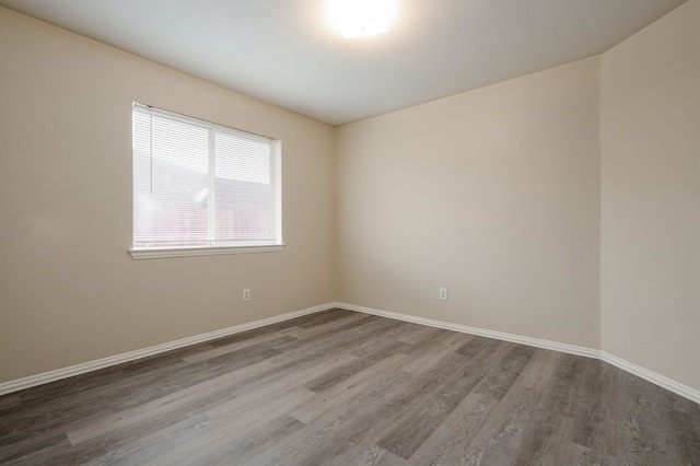 spare room with wood-type flooring