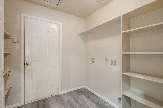 washroom featuring hookup for a washing machine and hardwood / wood-style floors