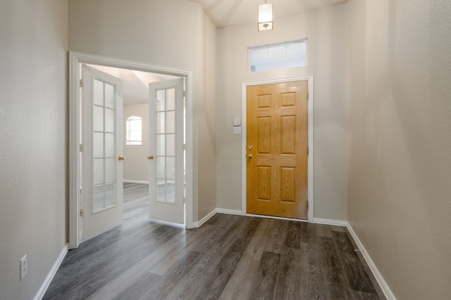 foyer with dark hardwood / wood-style floors and french doors