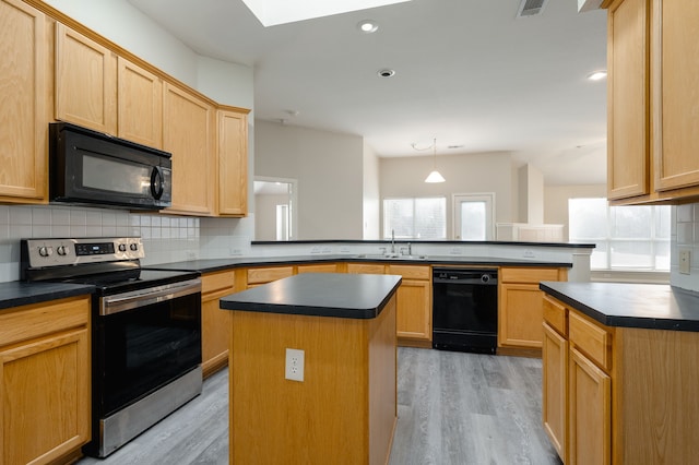 kitchen with backsplash, black appliances, kitchen peninsula, and a kitchen island