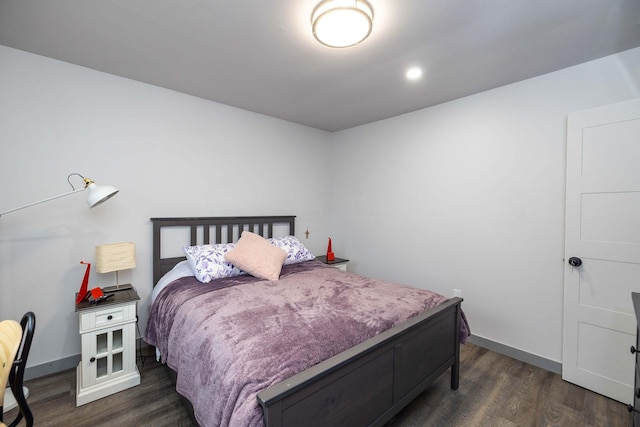 bedroom with dark hardwood / wood-style floors