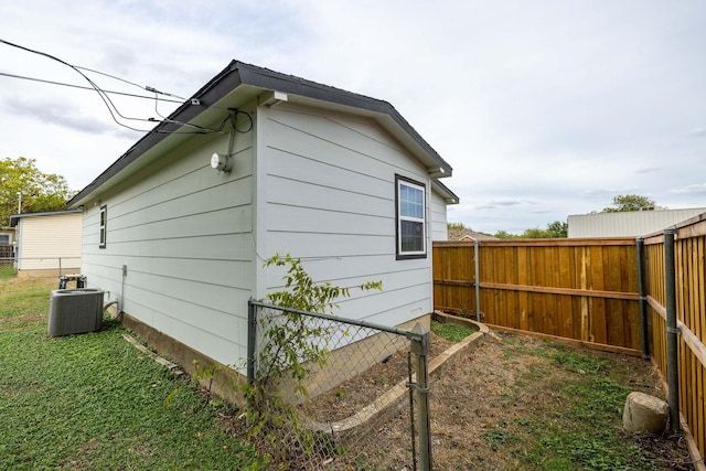 view of side of property with central air condition unit