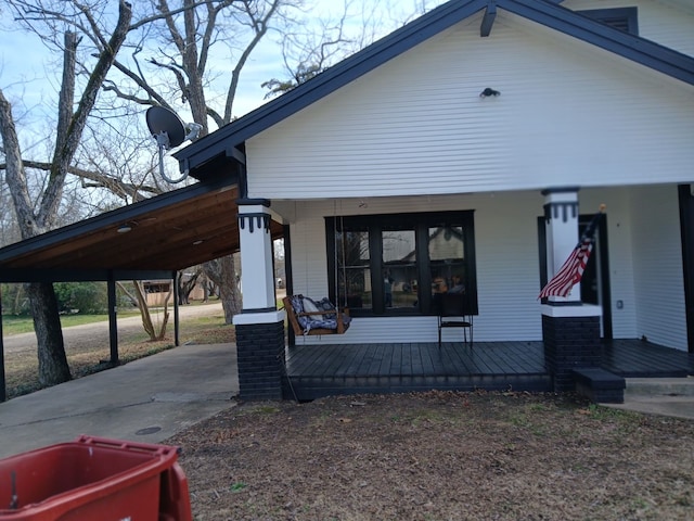 exterior space featuring a carport and a porch