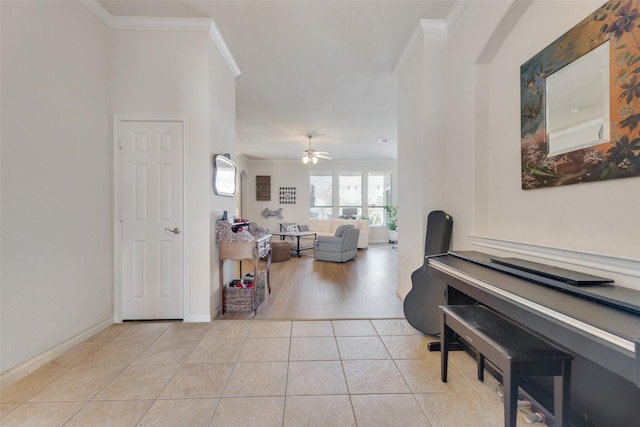 entryway with baseboards, ceiling fan, tile patterned flooring, and crown molding