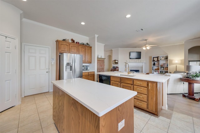 kitchen featuring black dishwasher, light countertops, open floor plan, stainless steel fridge with ice dispenser, and a center island with sink