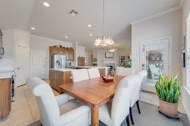 dining area with a chandelier, visible vents, crown molding, and light tile patterned flooring