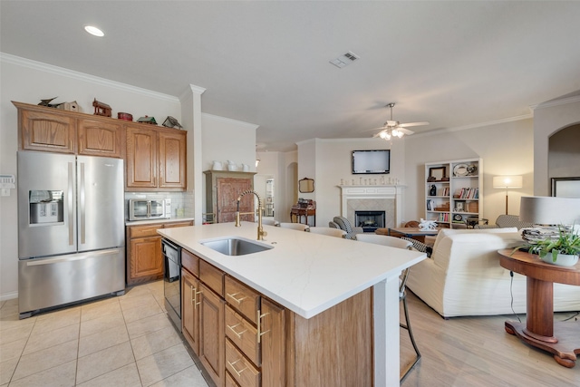 kitchen with a fireplace, light countertops, visible vents, appliances with stainless steel finishes, and a sink