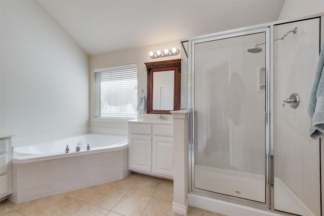 full bathroom with a garden tub, lofted ceiling, vanity, a shower stall, and tile patterned floors